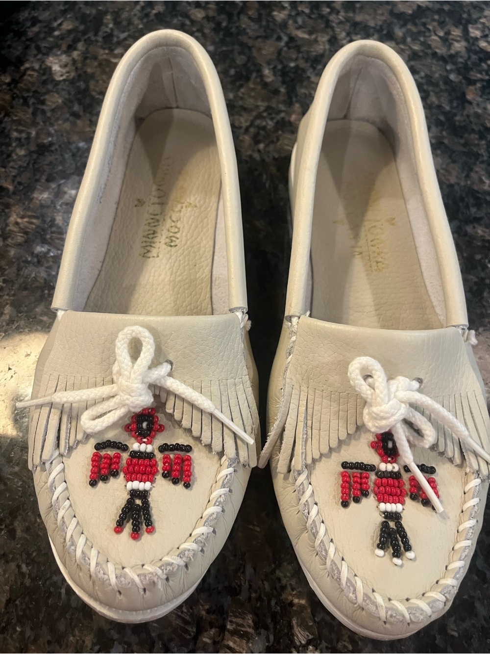 Minnetonka Cream Beaded Thunderbird Fringe Moccasins